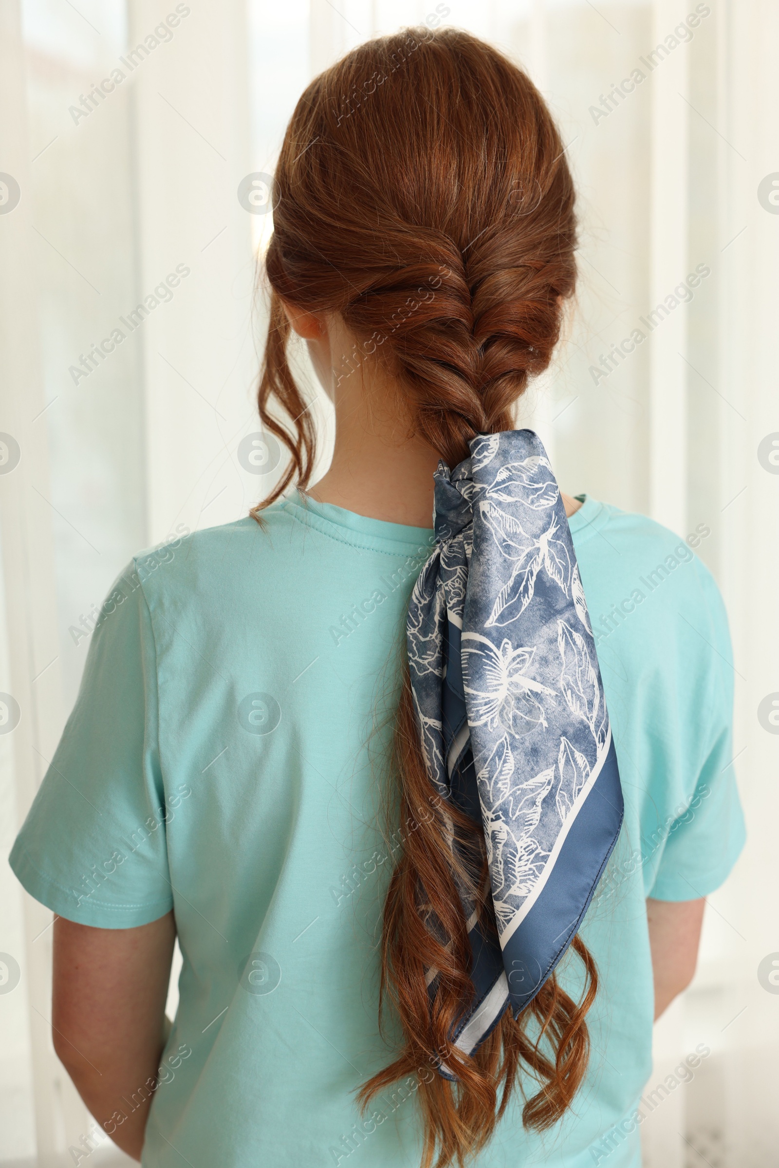 Photo of Teenage girl with stylish bandana indoors, back view