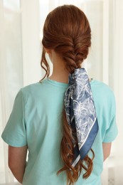 Teenage girl with stylish bandana indoors, back view