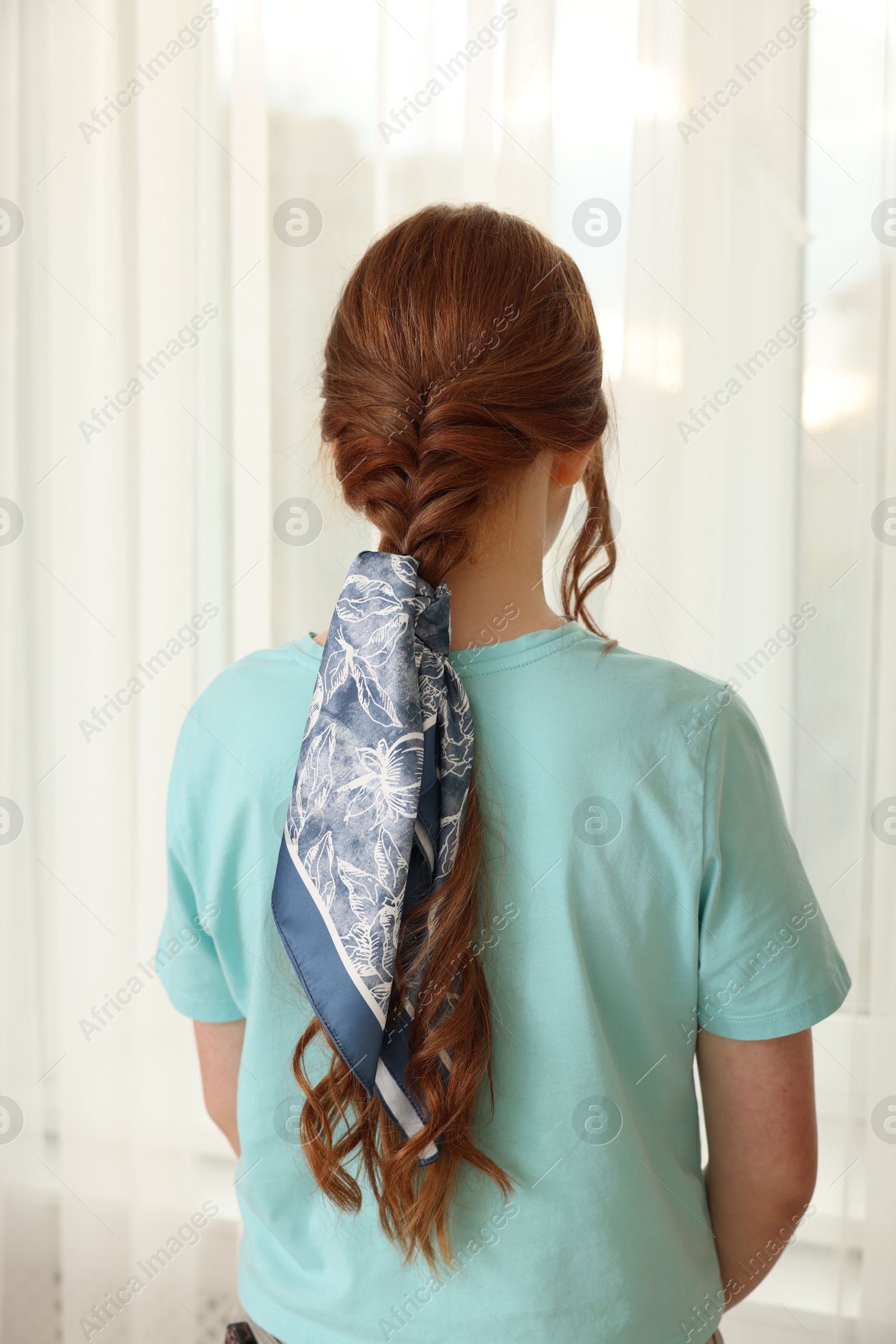 Photo of Teenage girl with stylish bandana indoors, back view