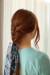 Photo of Teenage girl with stylish bandana indoors, back view