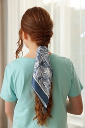 Photo of Teenage girl with stylish bandana indoors, back view