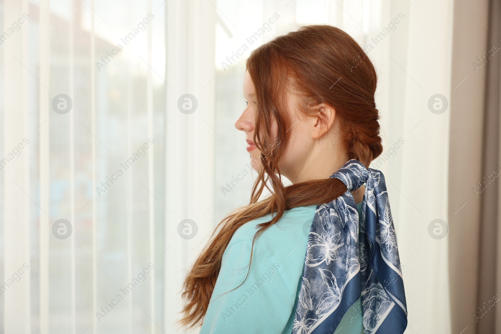 Photo of Teenage girl with long hair and stylish bandana indoors, space for text