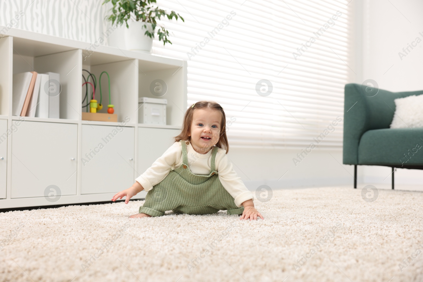 Photo of Cute little baby on floor at home