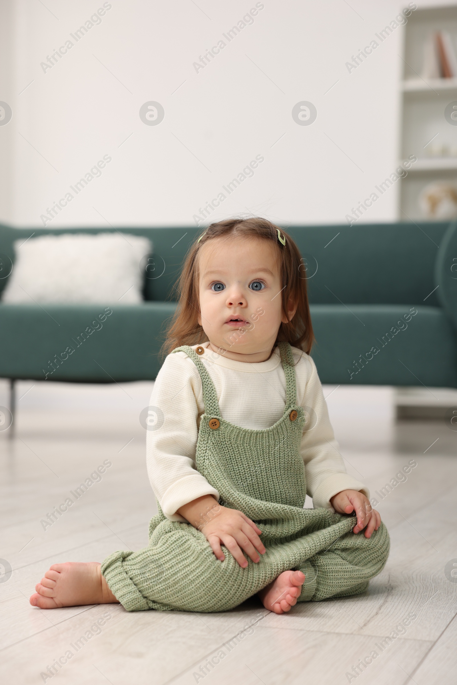 Photo of Cute little baby on floor at home