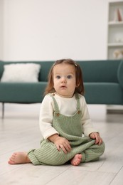 Photo of Cute little baby on floor at home