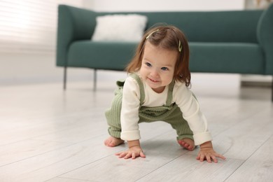 Photo of First steps. Cute little baby learning to walk at home, space for text