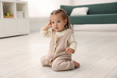 Cute little baby on floor at home