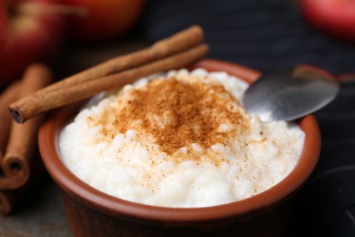 Photo of Delicious rice pudding with cinnamon on table, closeup