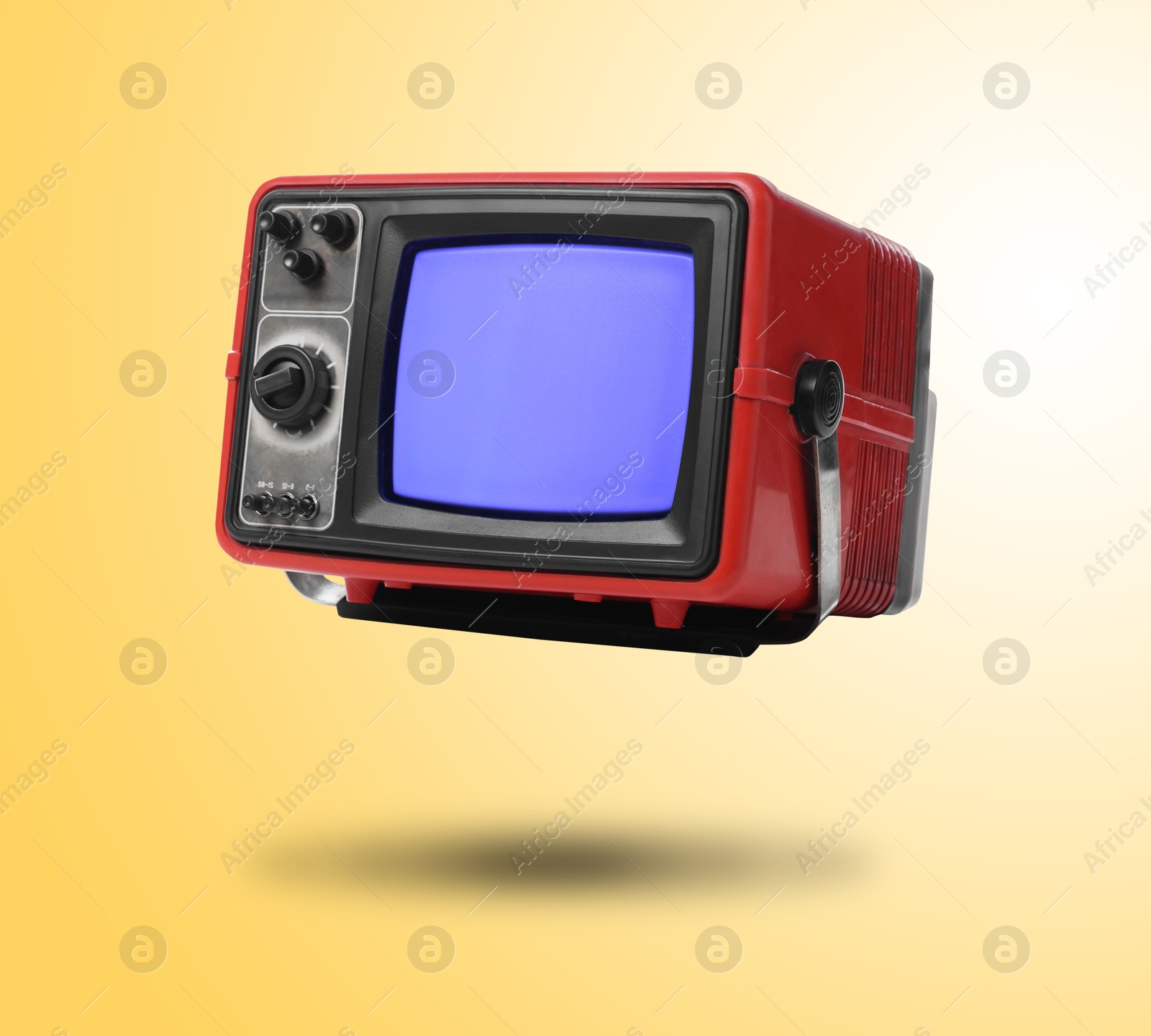 Image of Retro TV set in air on golden background