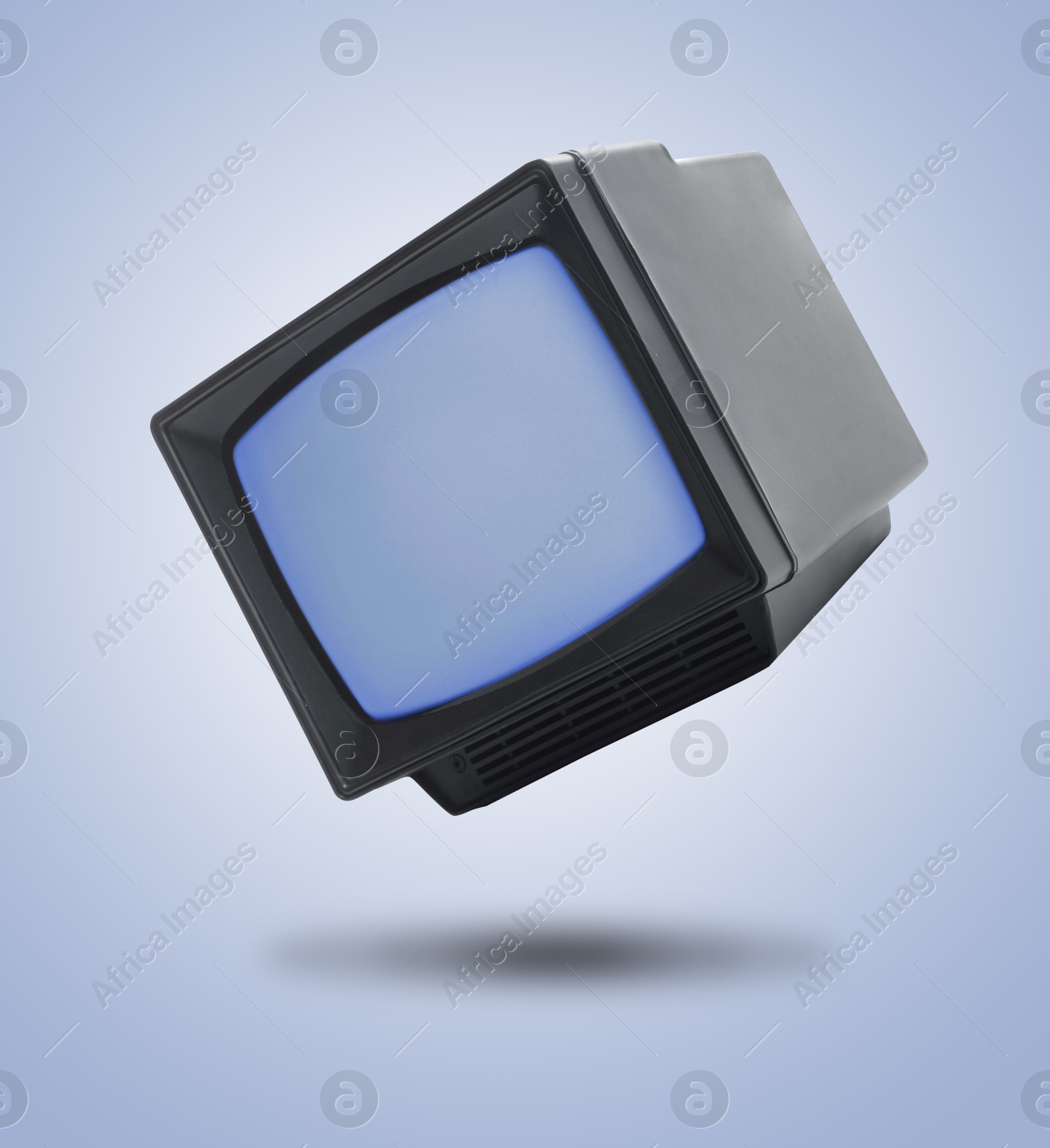 Image of Retro TV set in air on light blue background