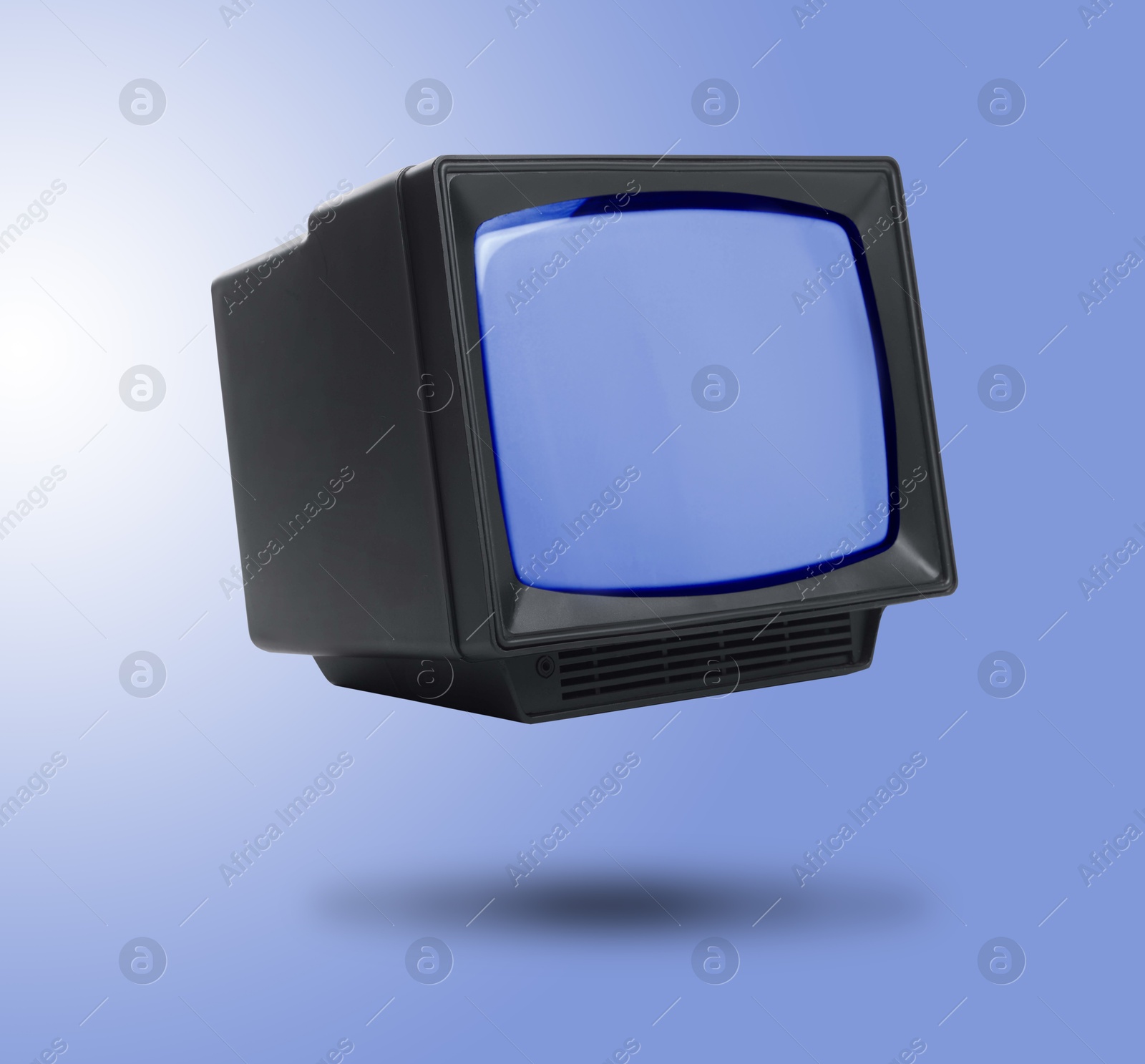 Image of Retro TV set in air on pale blue background