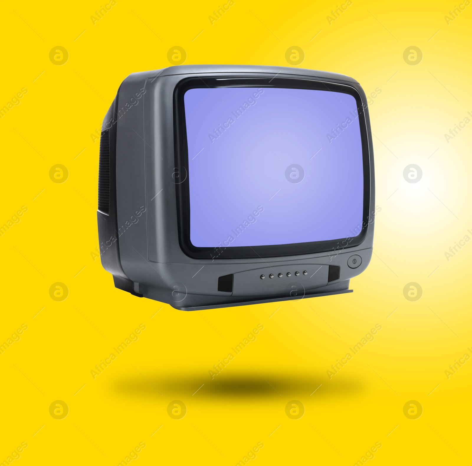 Image of Retro TV set in air on golden background