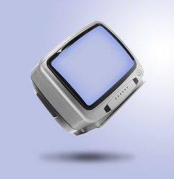 Image of Retro TV set in air on light blue background