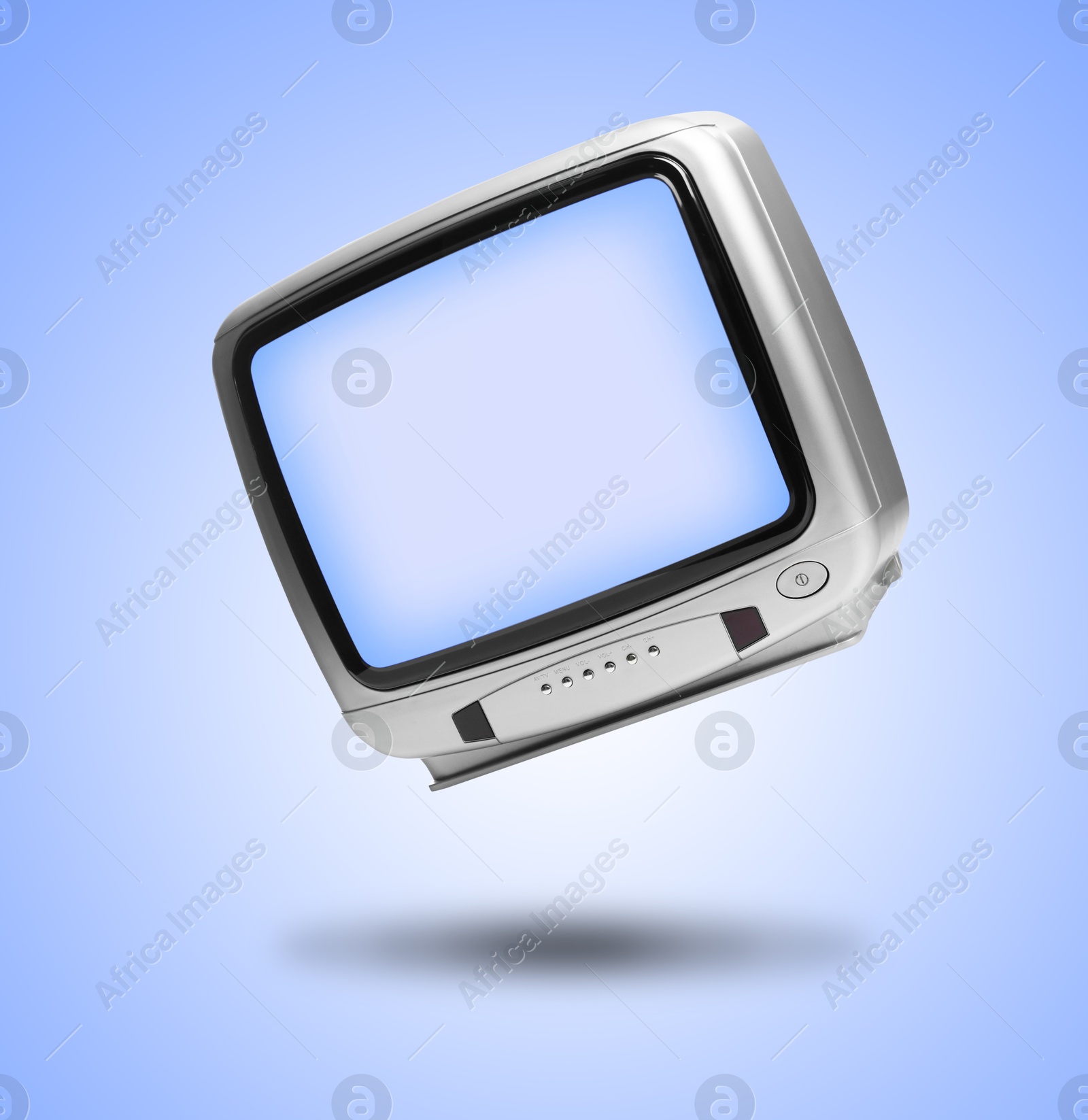 Image of Retro TV set in air on light blue background