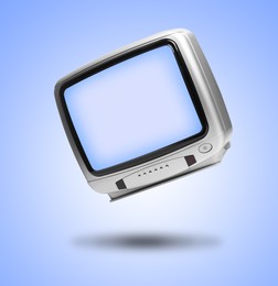 Image of Retro TV set in air on light blue background