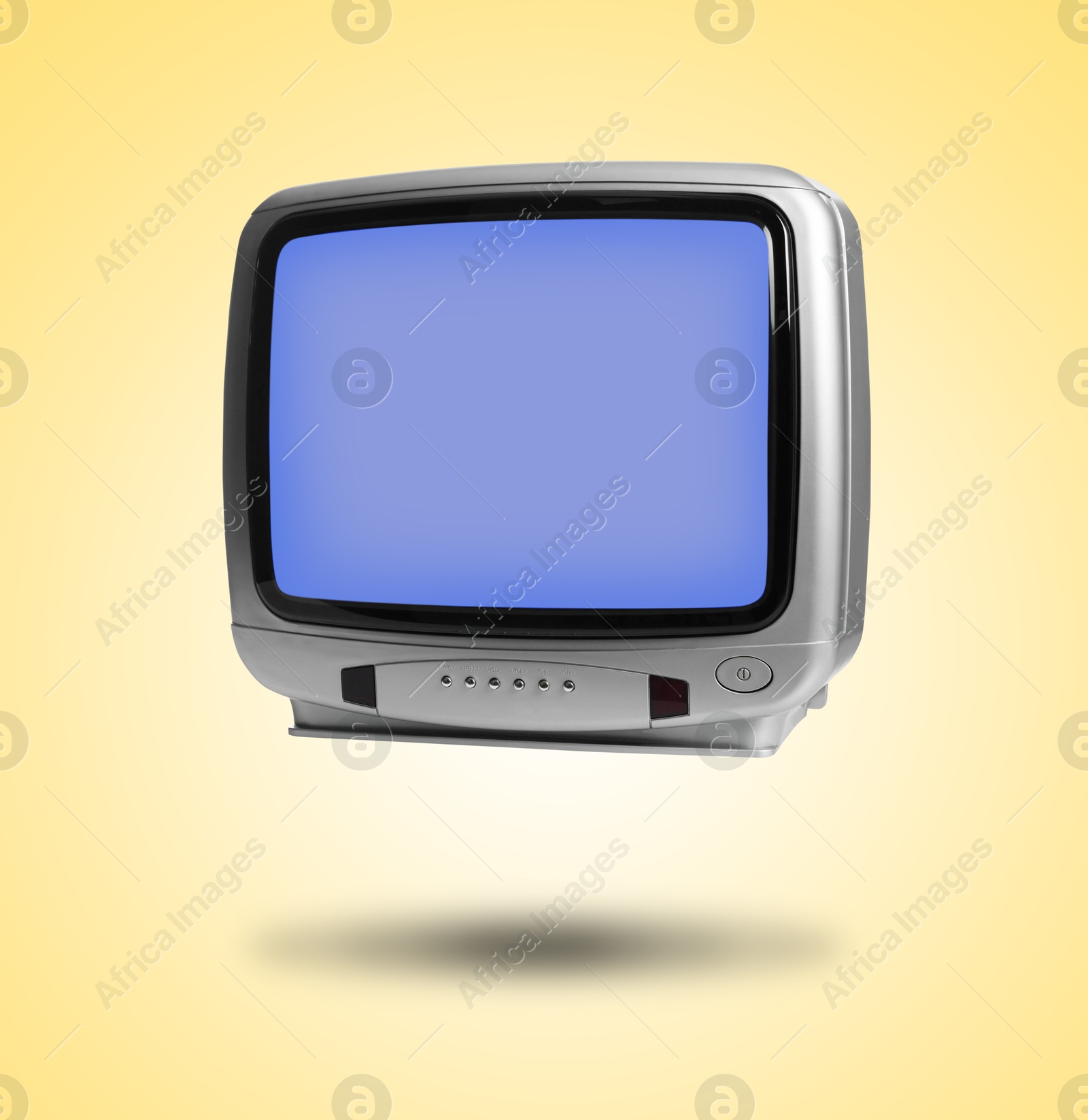 Image of Retro TV set in air on golden background