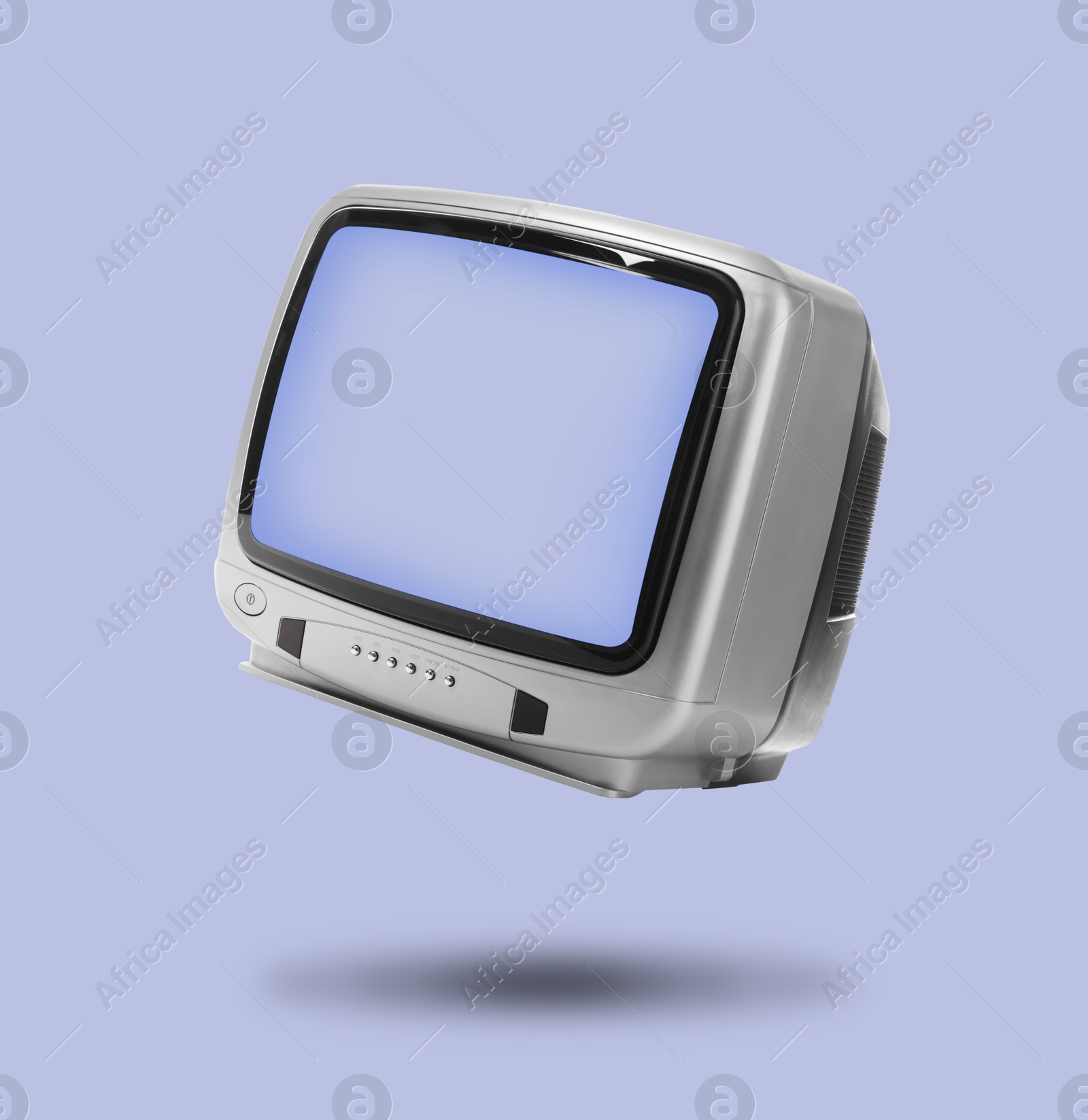 Image of Retro TV set in air on light blue background