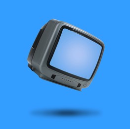 Image of Retro TV set in air on blue background