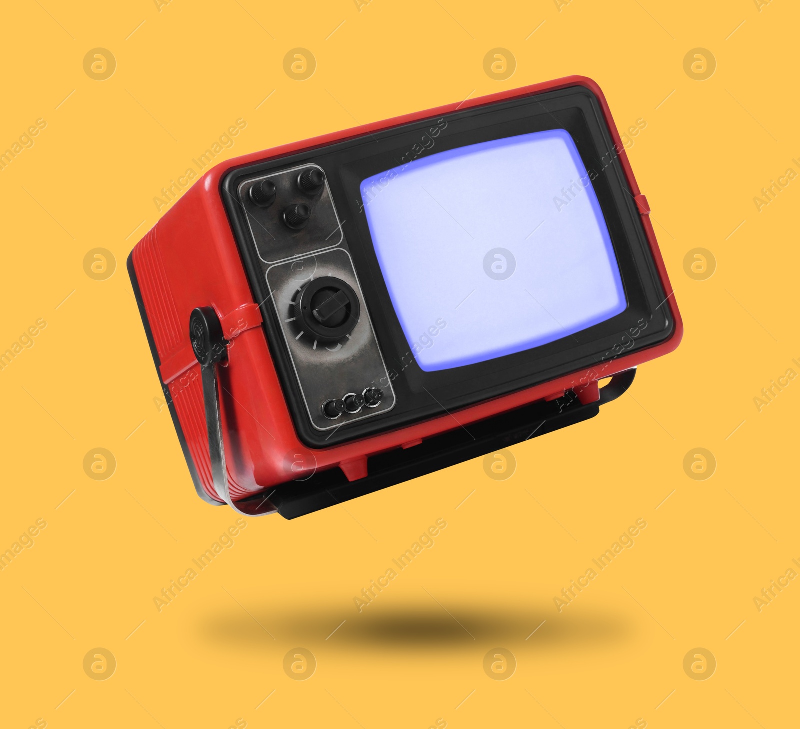 Image of Retro TV set in air on orange background