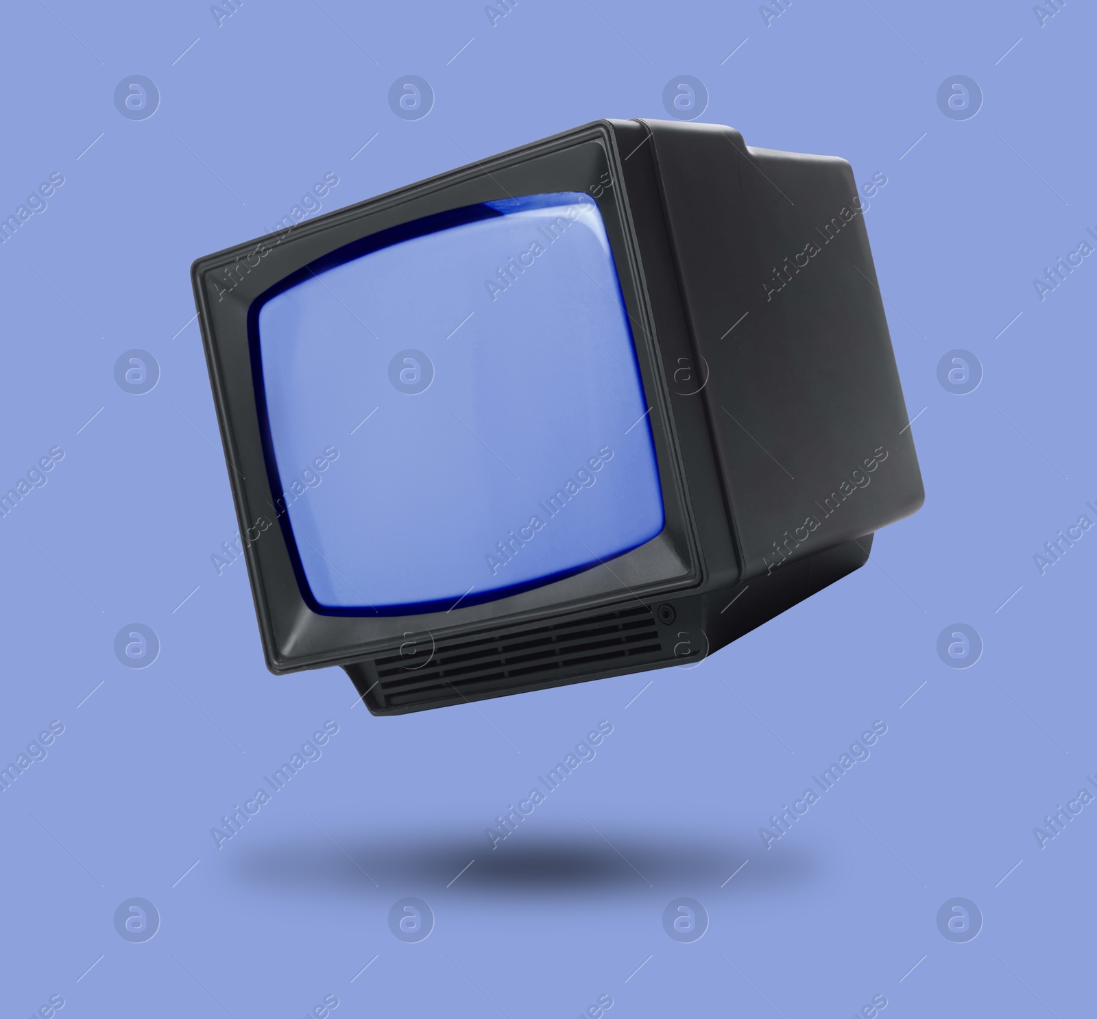 Image of Retro TV set in air on violet blue background