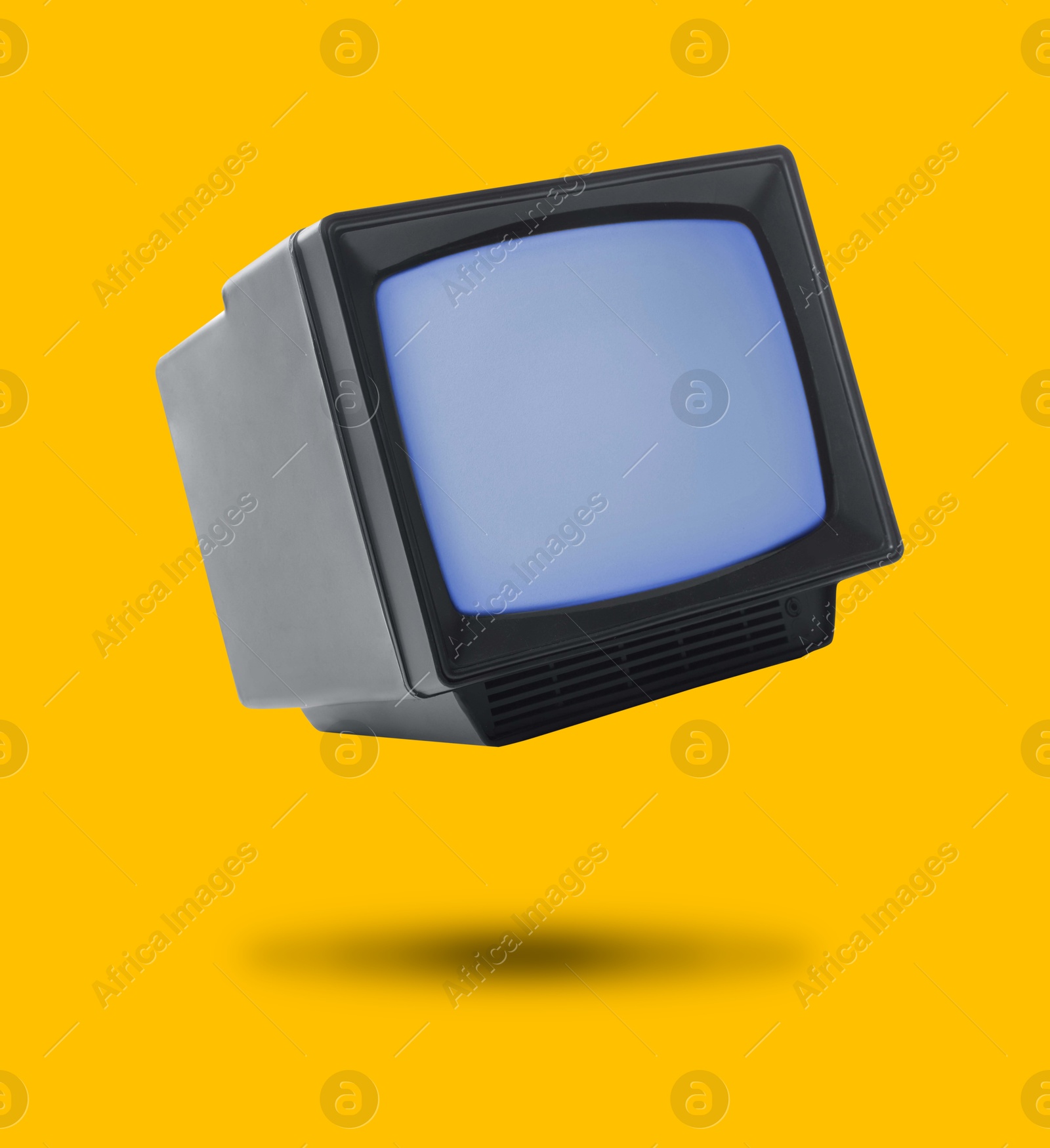 Image of Retro TV set in air on orange background