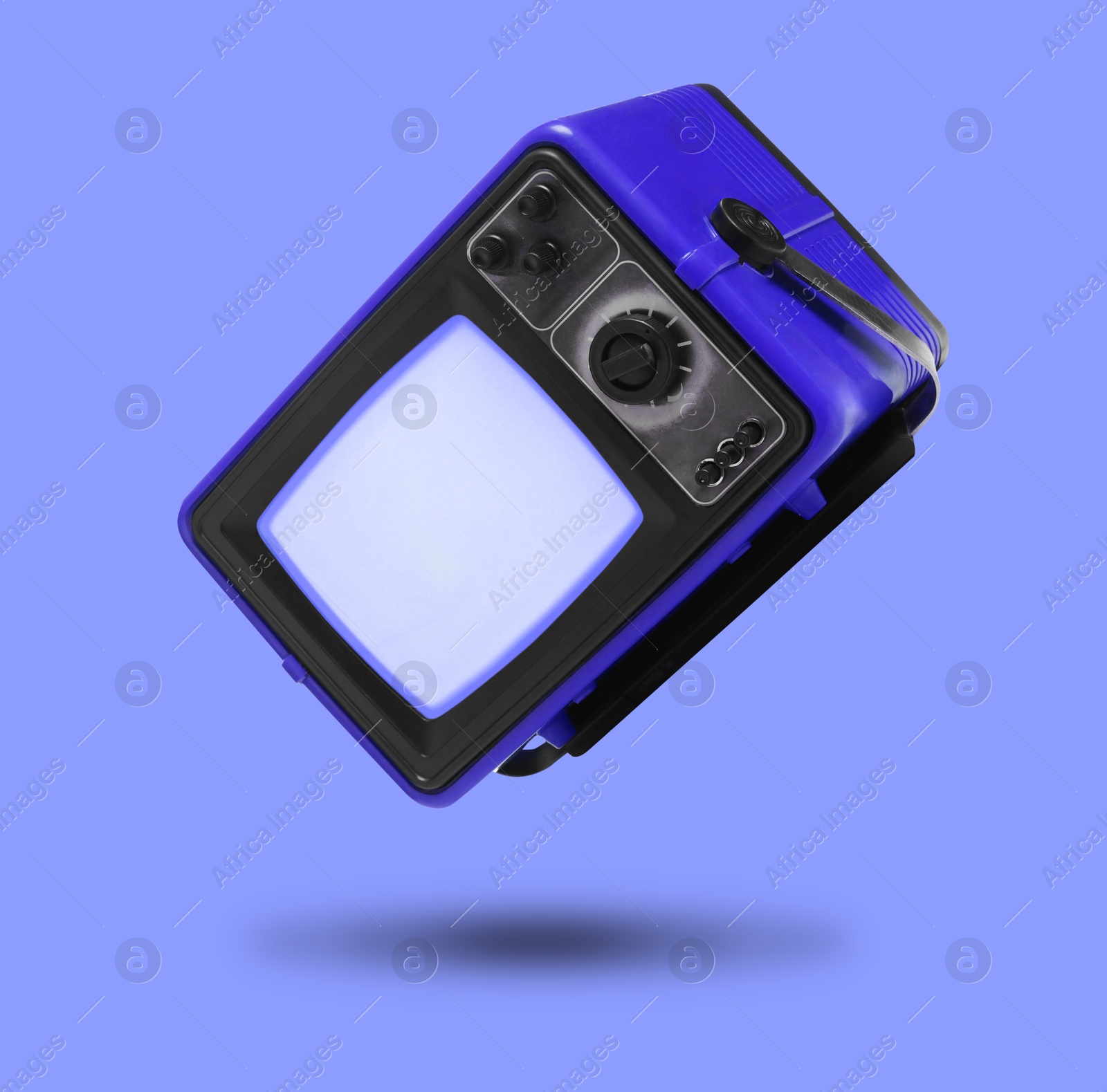 Image of Retro TV set in air on violet blue background