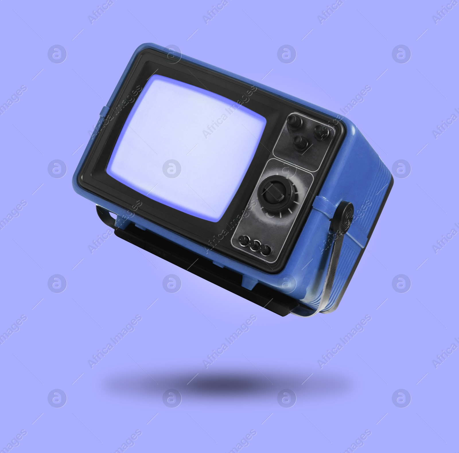 Image of Retro TV set in air on violet blue background