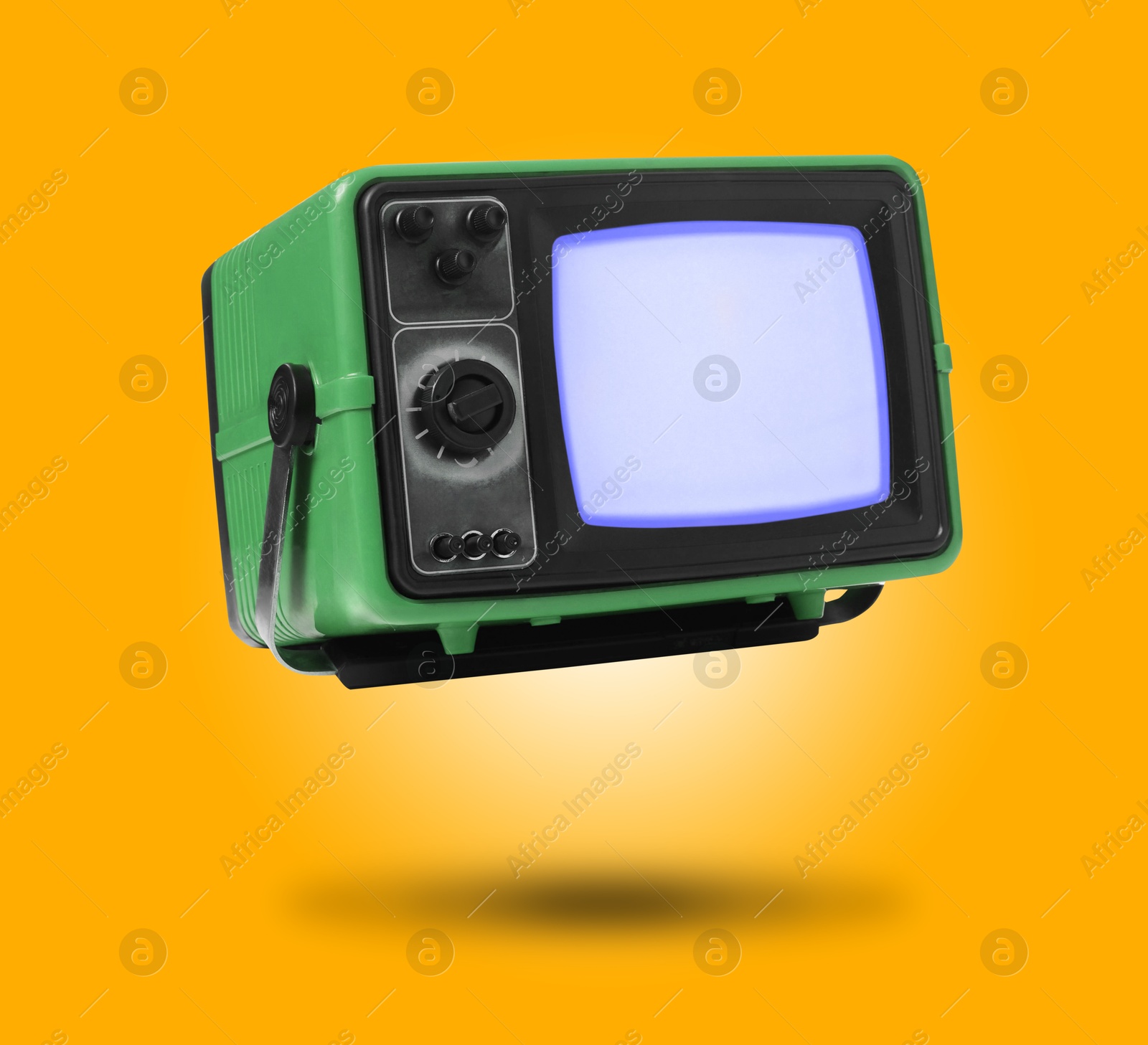 Image of Retro TV set in air on orange background