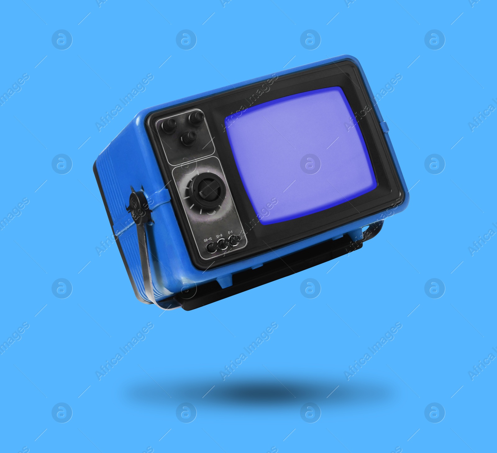 Image of Retro TV set in air on blue background