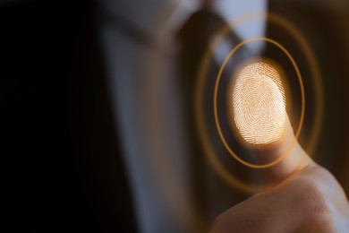 Image of Businessman scanning fingerprint on virtual screen. Biometric security system