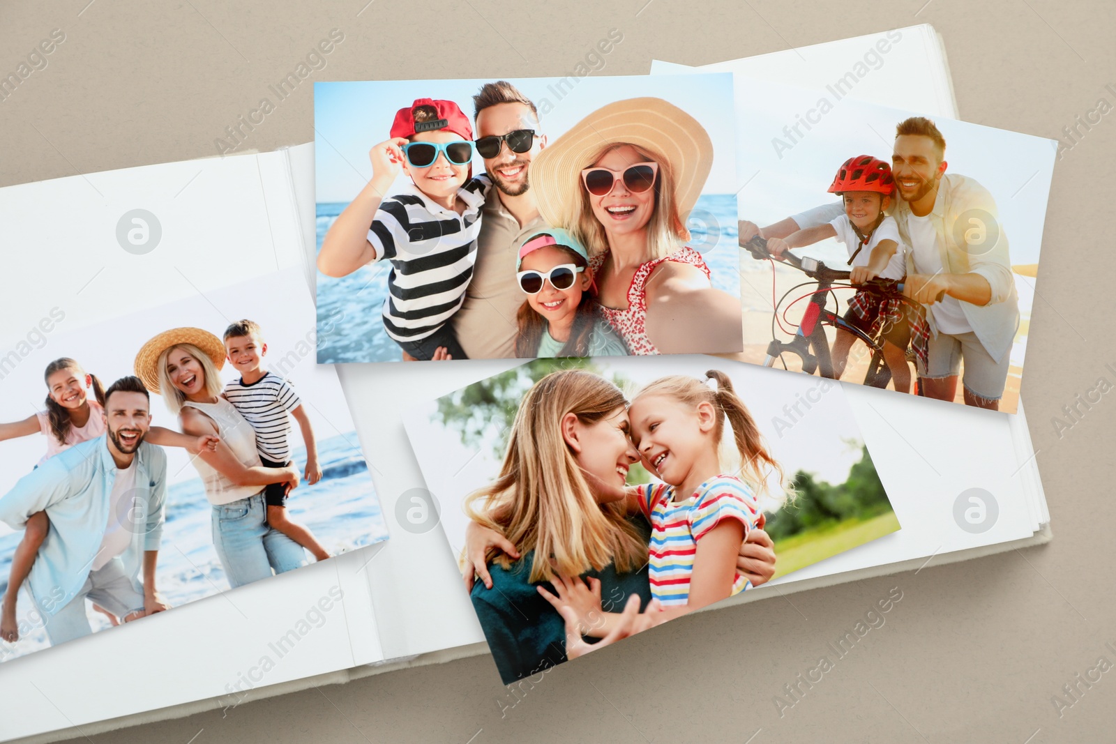 Photo of Open photo album with different photos on beige background, top view