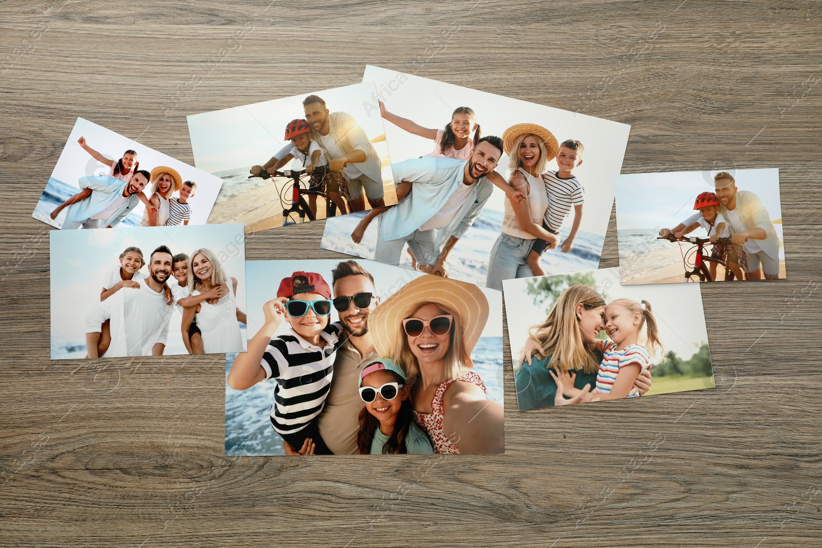 Photo of Different family photos on wooden table, flat lay