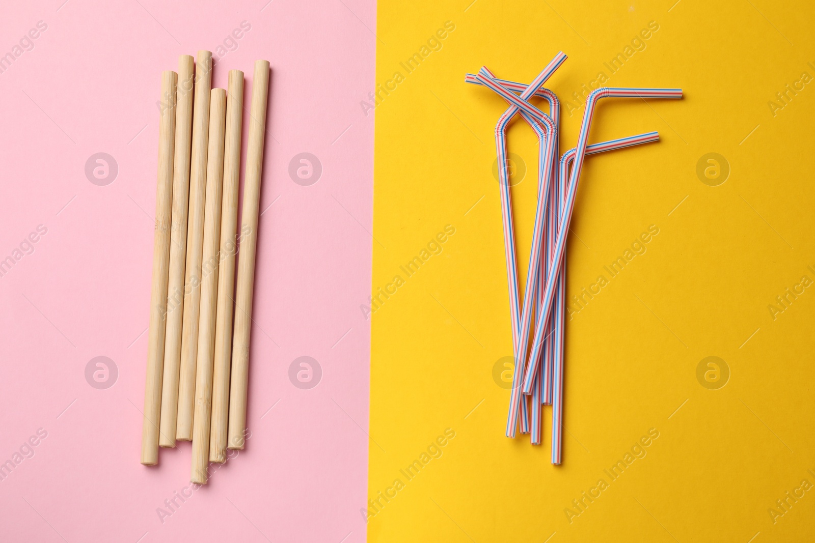 Photo of Different drinking straws on color background, flat lay