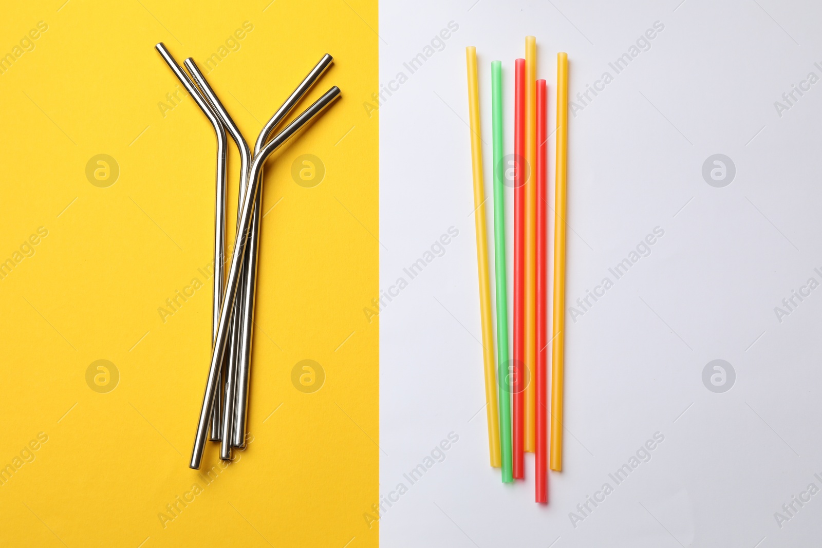 Photo of Different drinking straws on color background, flat lay