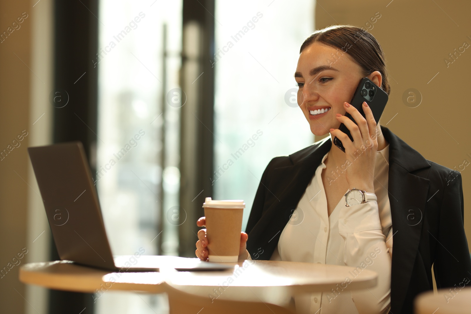 Photo of Woman in stylish formal suit working at table indoors