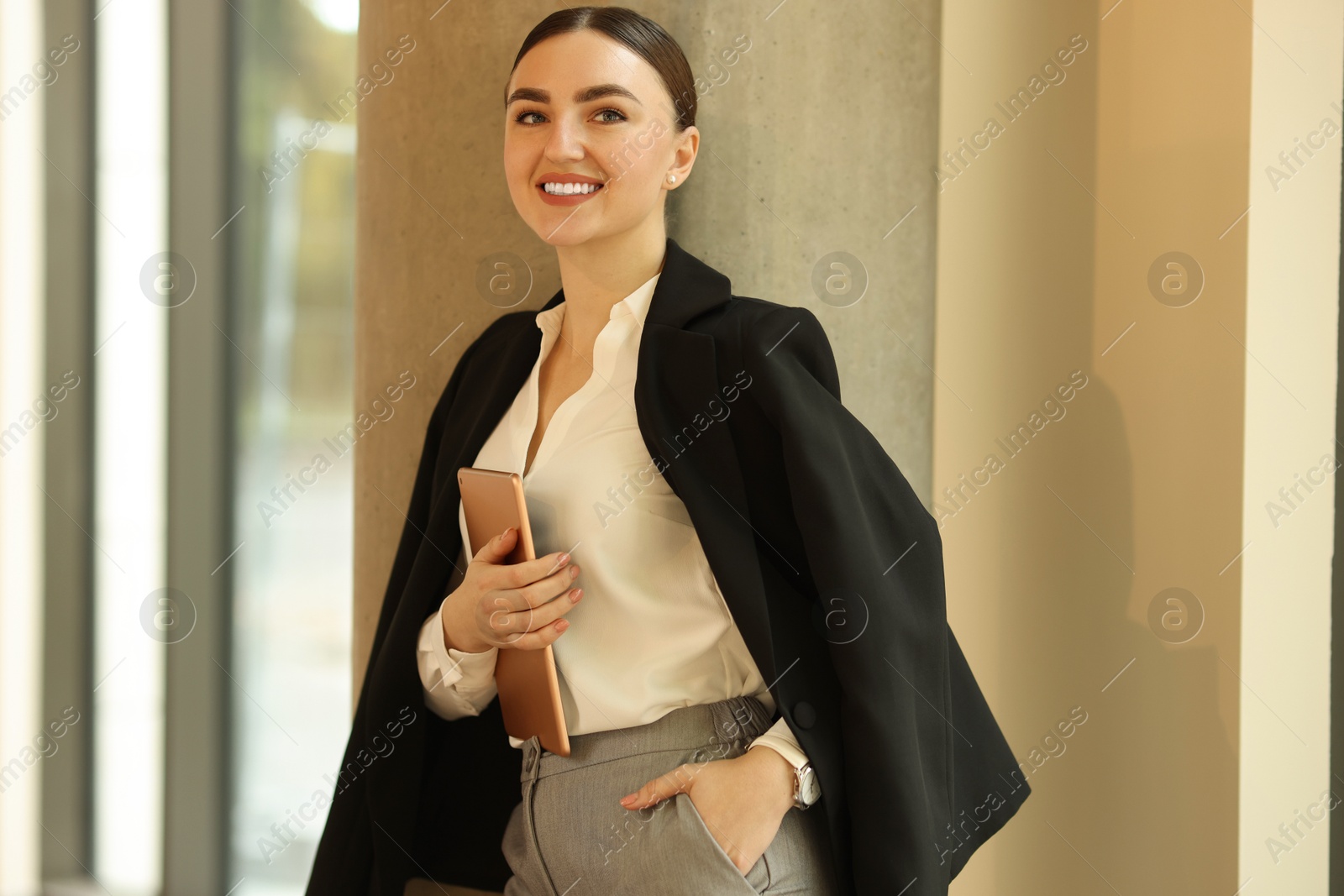 Photo of Woman in stylish formal suit with tablet indoors