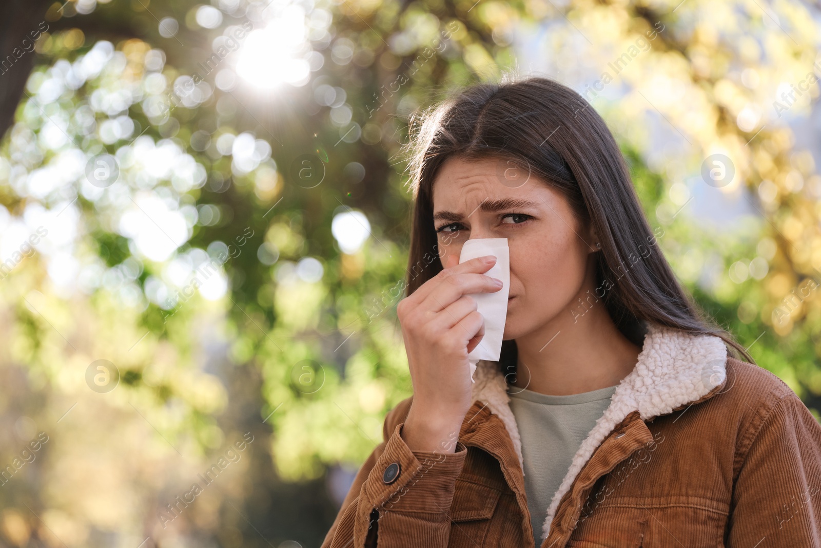 Photo of Woman with runny nose in park, space for text