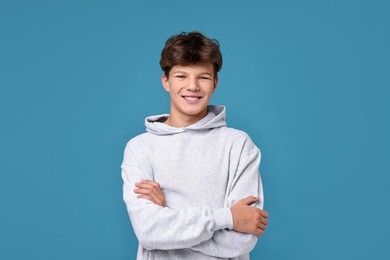 Photo of Portrait of happy teenage boy on light blue background