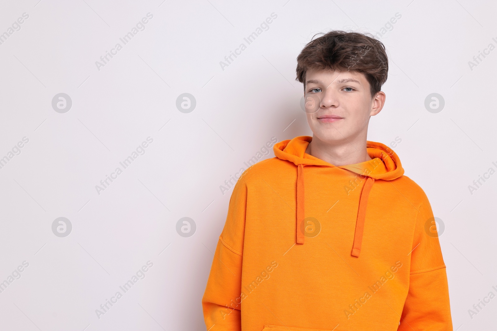 Photo of Portrait of teenage boy on white background, space for text