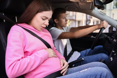 Photo of Pregnant woman travelling with her husband by car