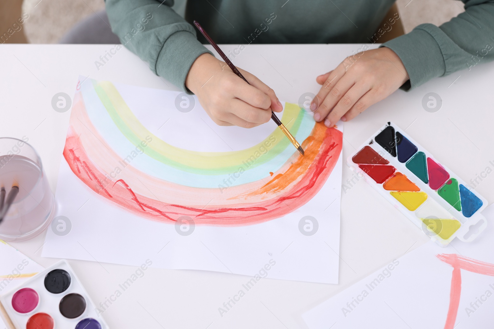 Photo of Little boy drawing at white table indoors, above view