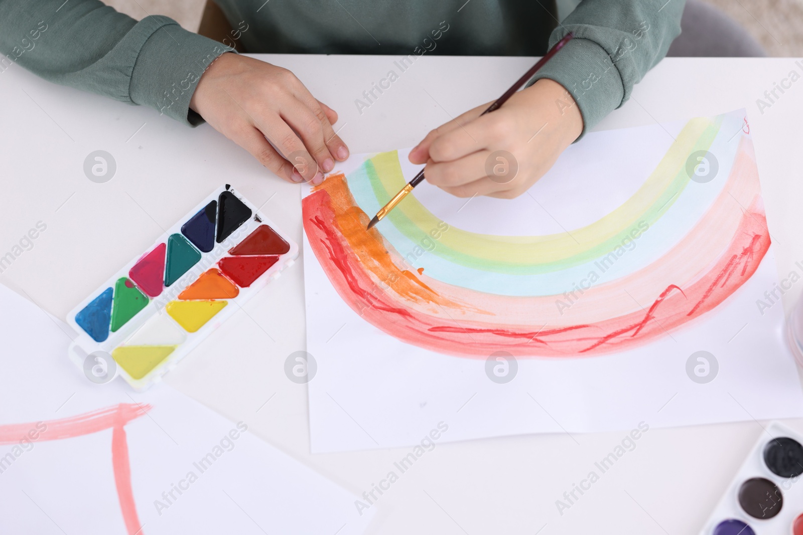 Photo of Little boy drawing at white table indoors, above view