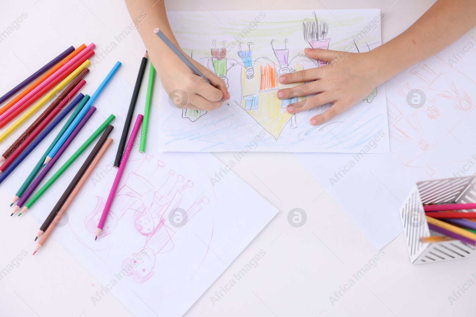 Photo of Boy drawing his family at white table indoors, top view