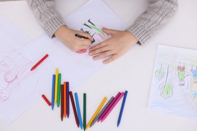 Photo of Boy drawing his family at white table, top view