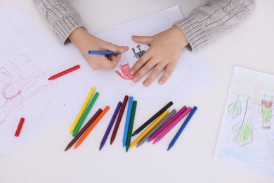 Photo of Boy drawing his family at white table, top view