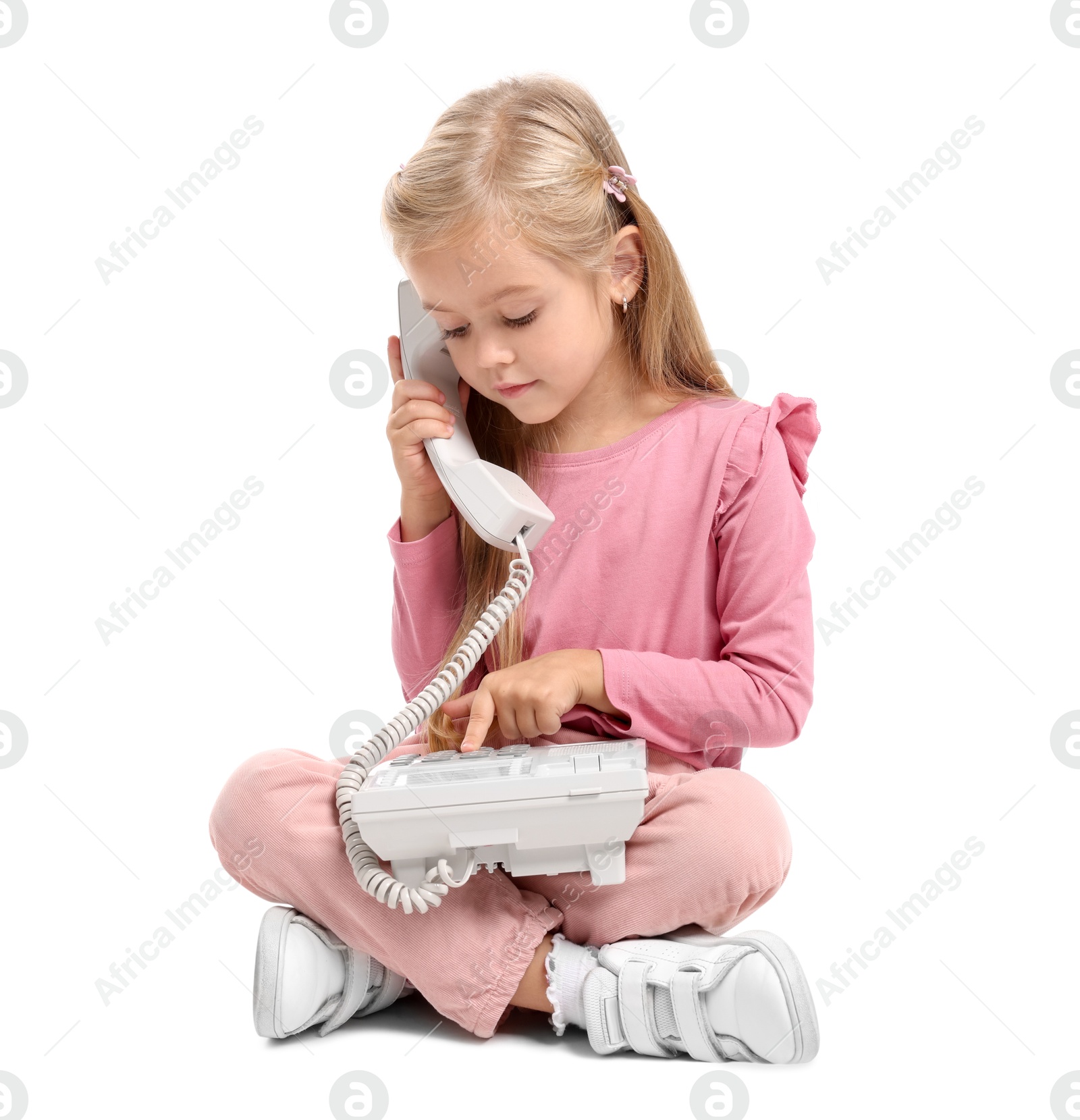 Photo of Cute little girl with telephone on white background