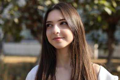 Photo of Portrait of beautiful teenage girl on city street