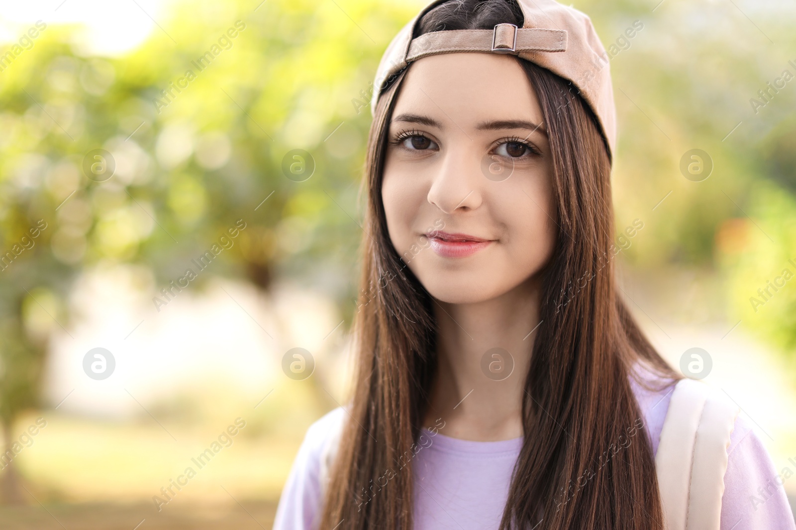 Photo of Portrait of teenage girl in stylish cap outdoors. Space for text