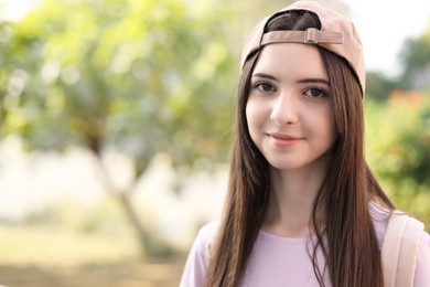 Photo of Portrait of teenage girl in stylish cap outdoors. Space for text