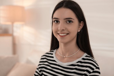 Photo of Portrait of smiling teenage girl at home